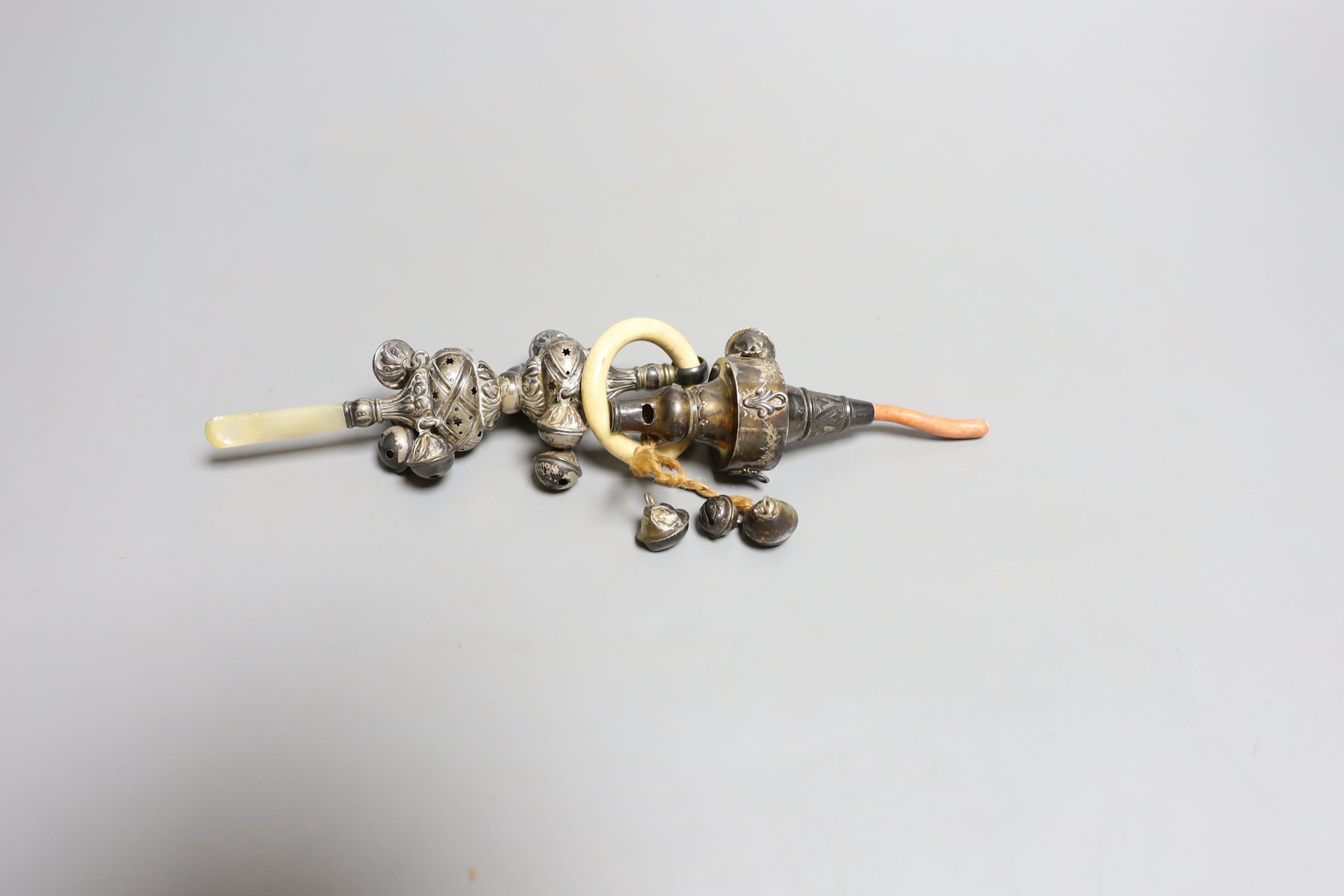 A George V silver, bone and mother of pearl mounted child's rattle, 16.1cm and a similar rattle with coral teether, both Crisford & Norris, Birmingham, 1911.